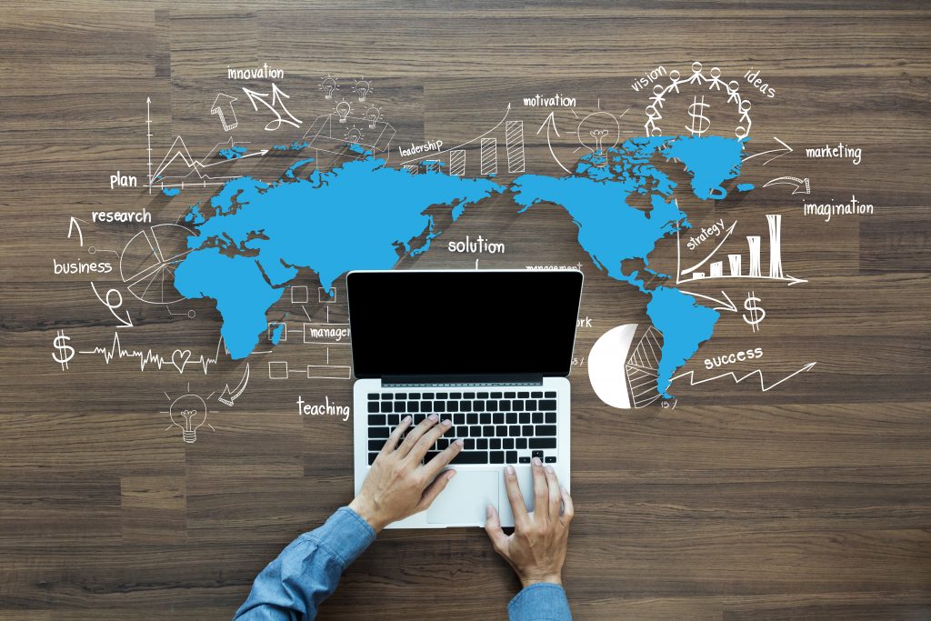 World map with creative drawing charts and graphs business success strategy plan ideas, With Man hand working on laptop computer keyboard with blank screen monitor, Top View